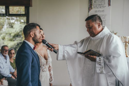 A priest is giving a bride a blessing