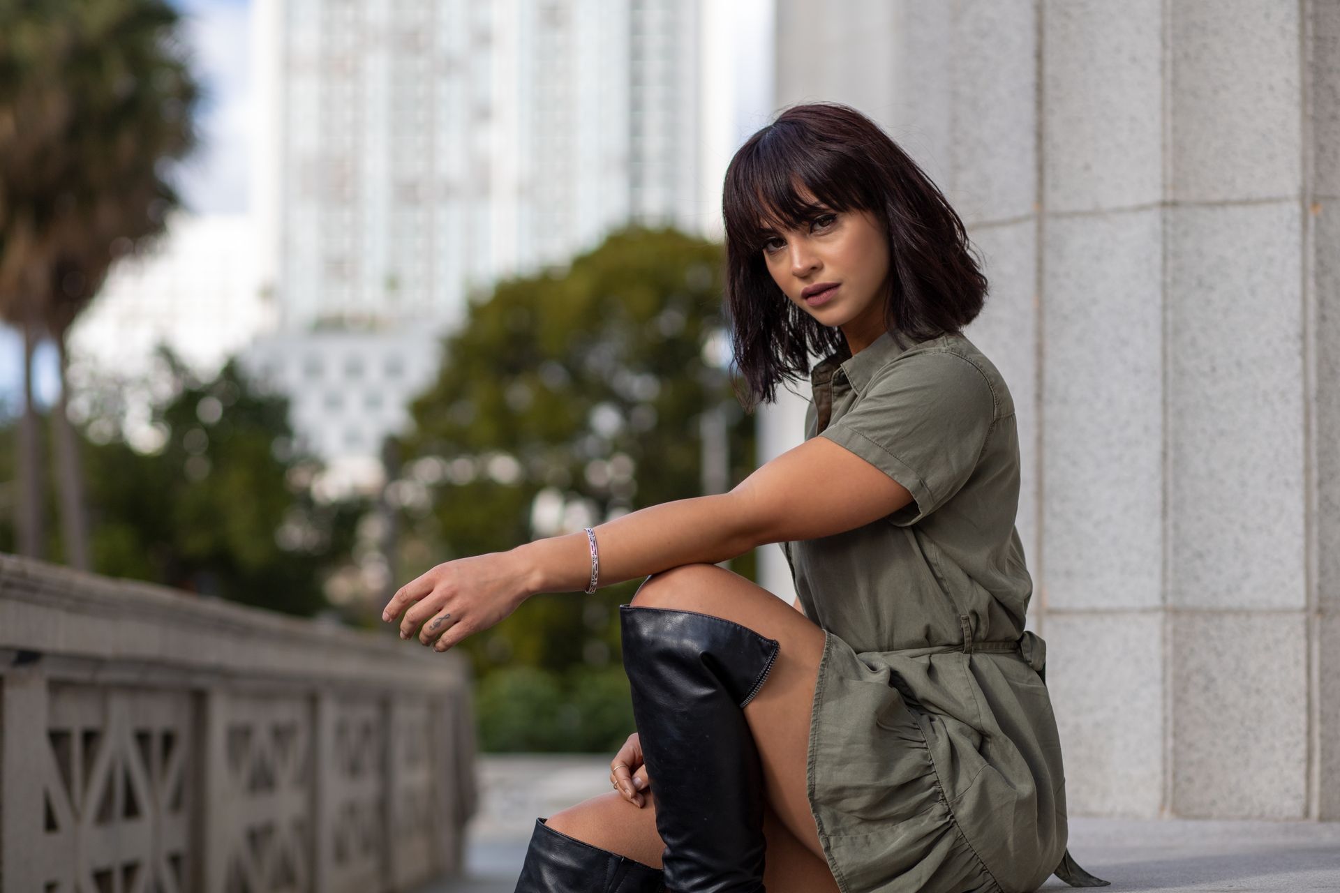 Stylish young woman posing in urban Miami setting, showcasing modern fashion.