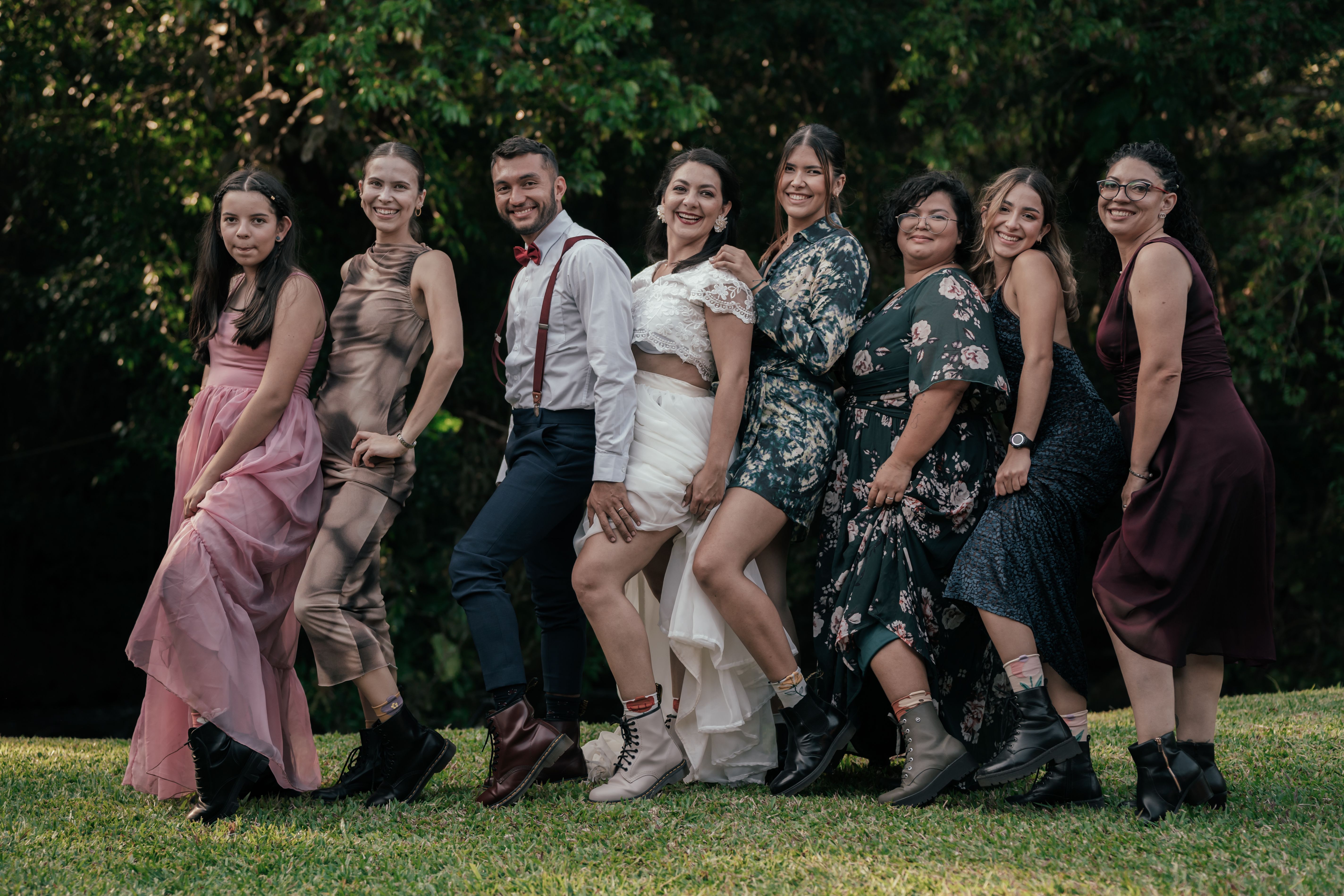 A group of people posing for a photo in the grass · Free Stock Photo