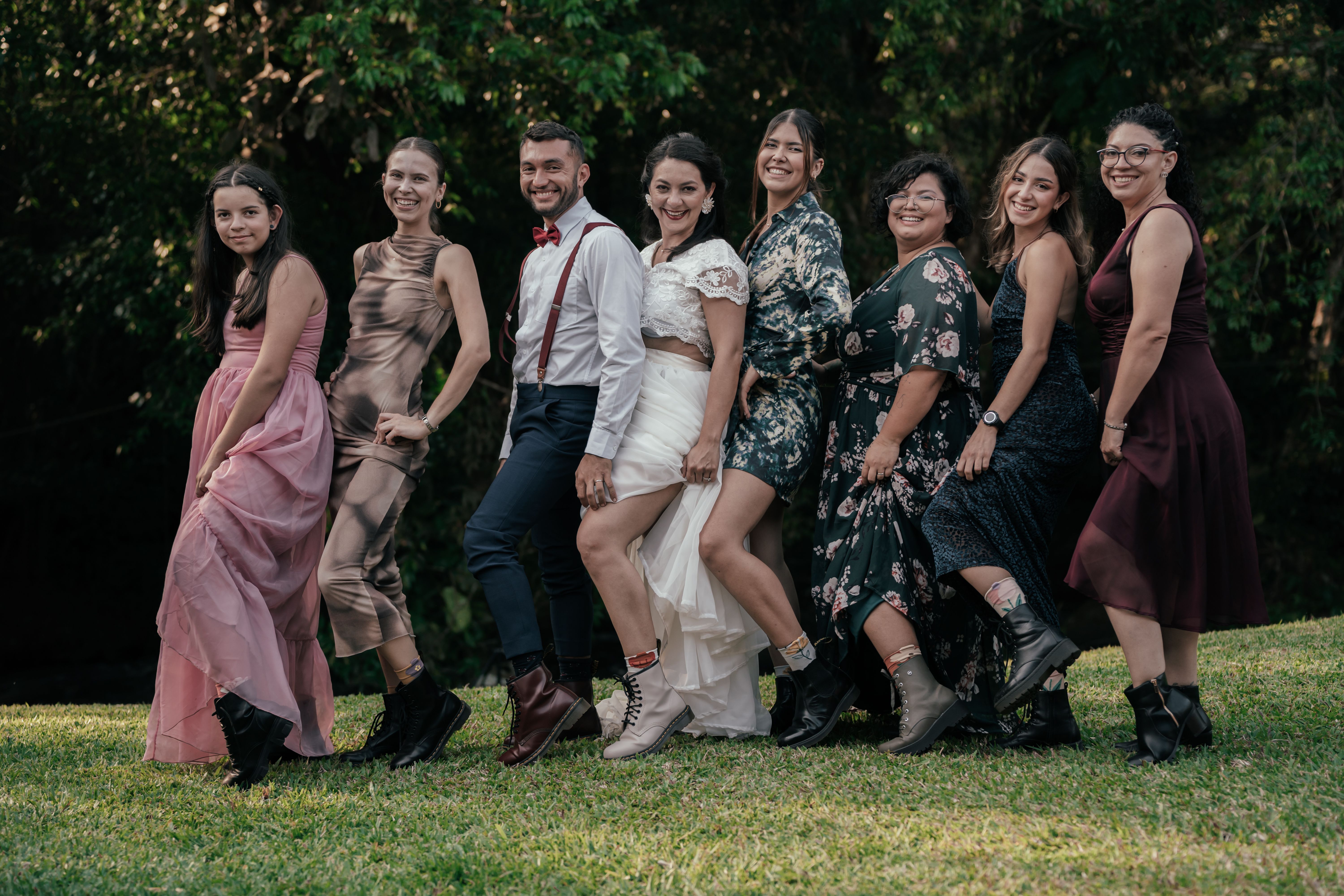 A group of people posing for a photo in the grass · Free Stock Photo