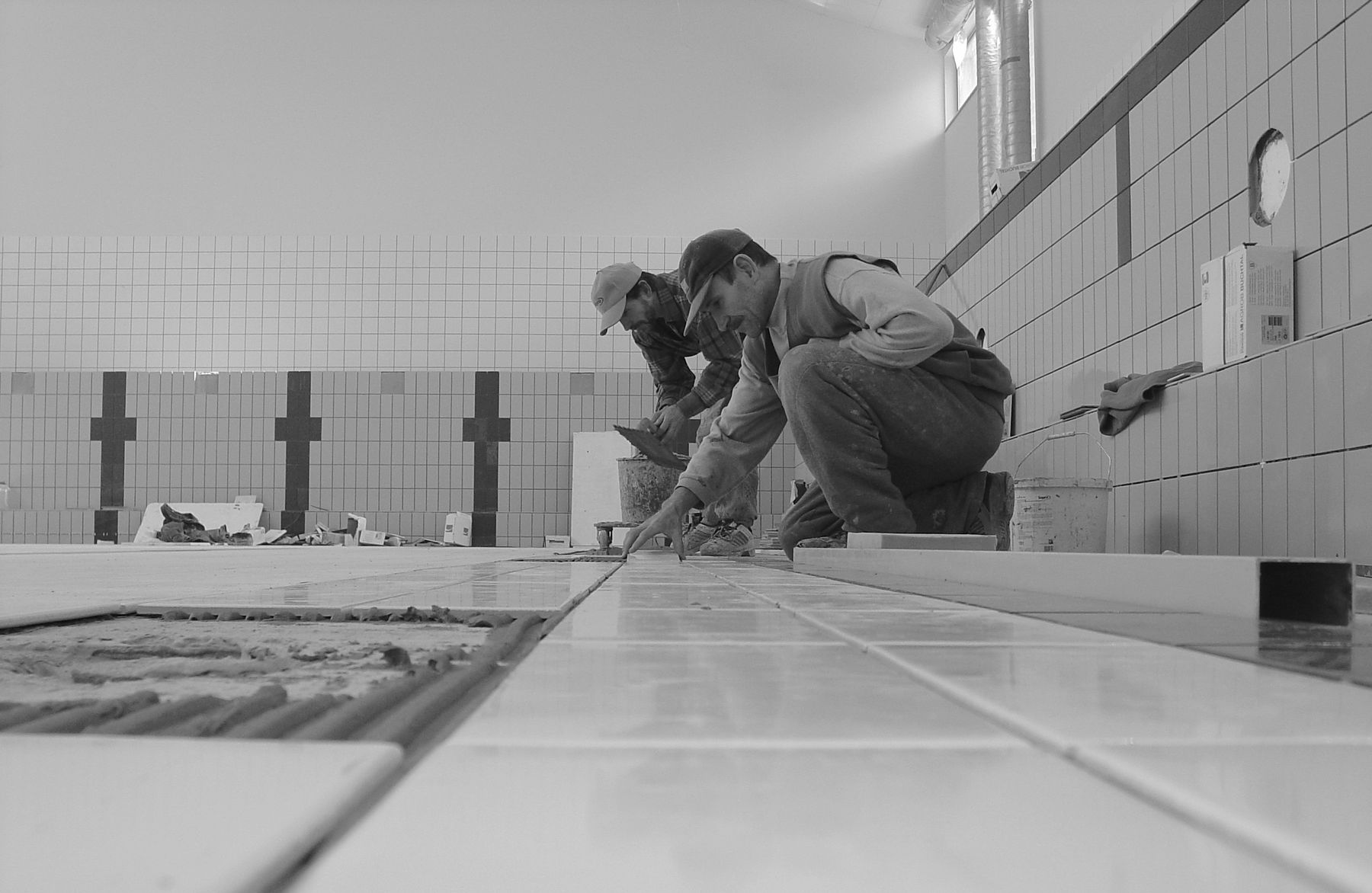 Professional tilers preparing a bathroom installation