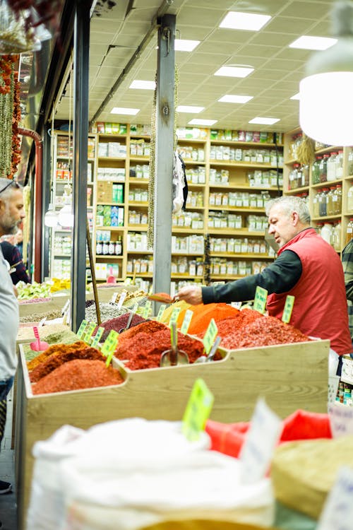 A man is standing in a store with spices