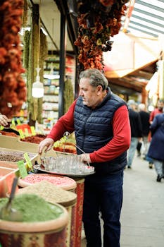 Man in a vest browsing spices at a colorful urban market with dried herbs and vibrant goods.