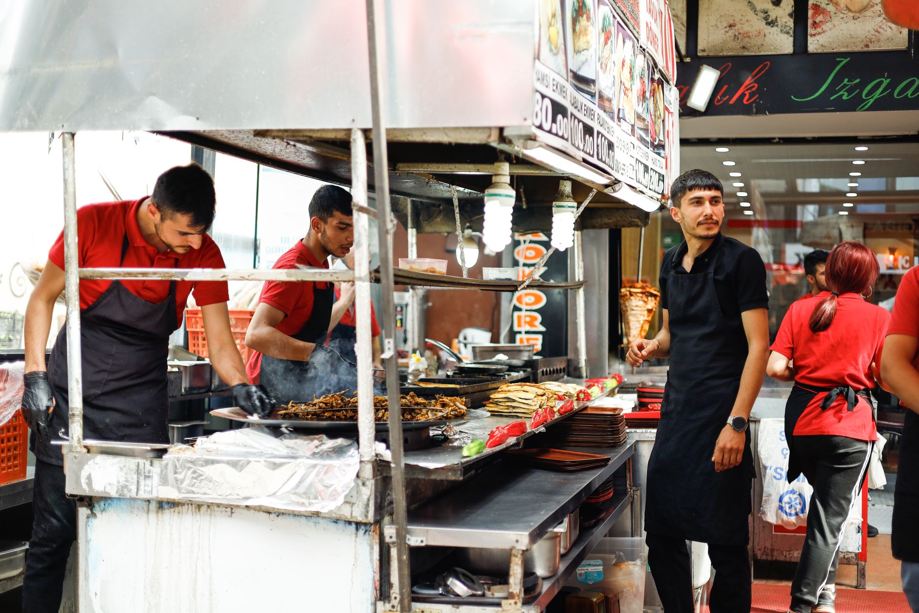 Street food vendors in an urban setting preparing a variety of meals. Perfect for food and urban culture themes.