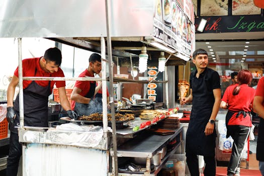 Street food vendors in an urban setting preparing a variety of meals. Perfect for food and urban culture themes.