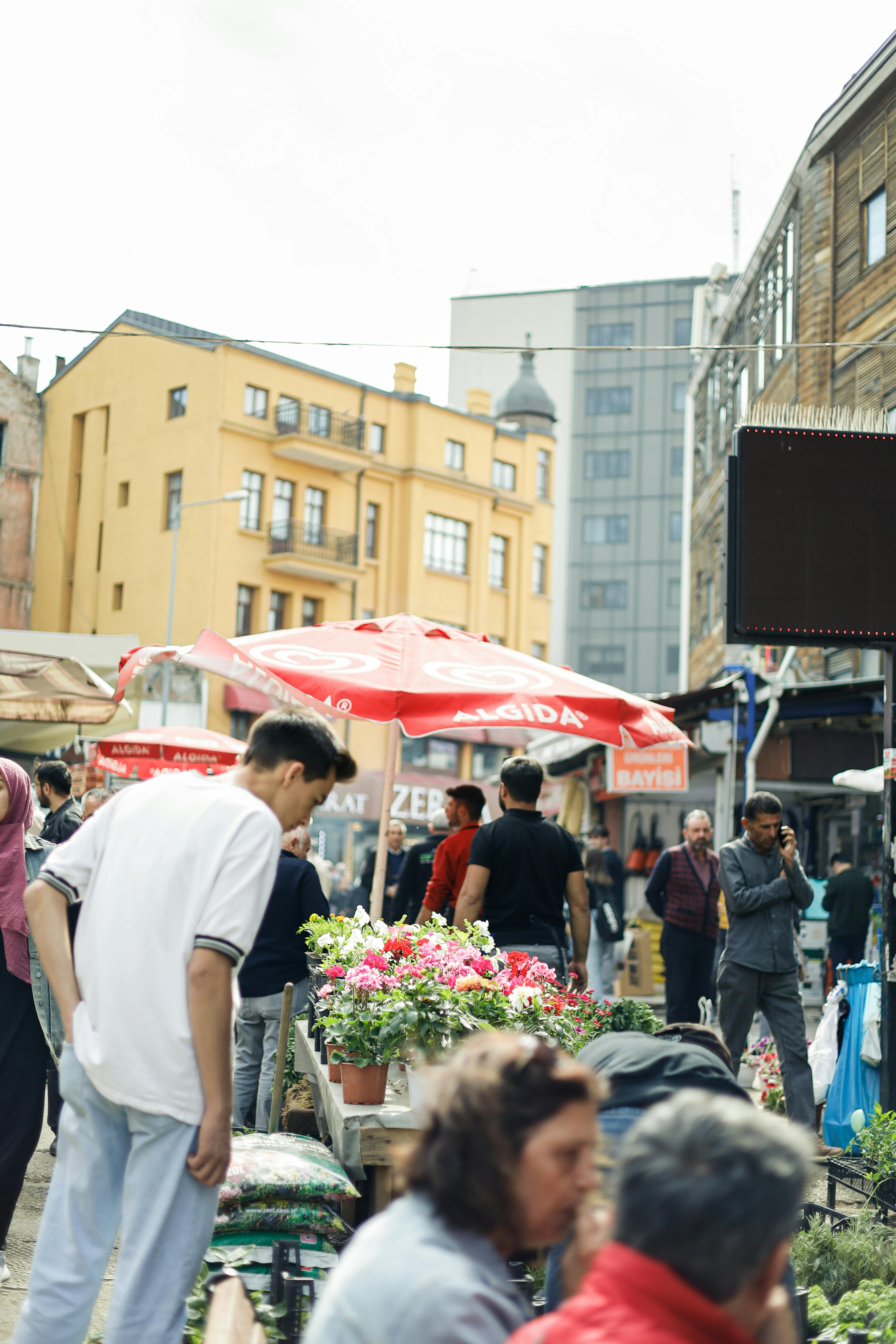 people at flowers market in city