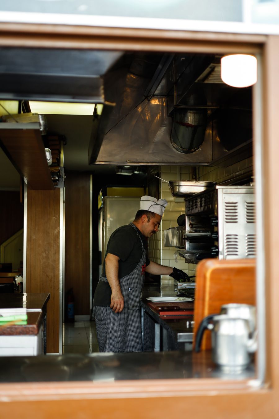 Chef preparing food in a professional restaurant kitchen