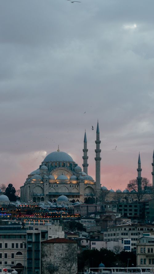Free Captivating view of Istanbul's New Mosque with its iconic minarets against a serene dusk sky. Stock Photo