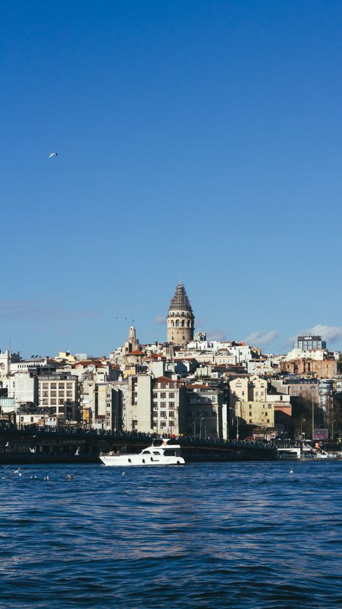 Free Scenic view of the Galata Tower surrounded by Istanbul's urban skyline and the Bosphorus. Stock Photo