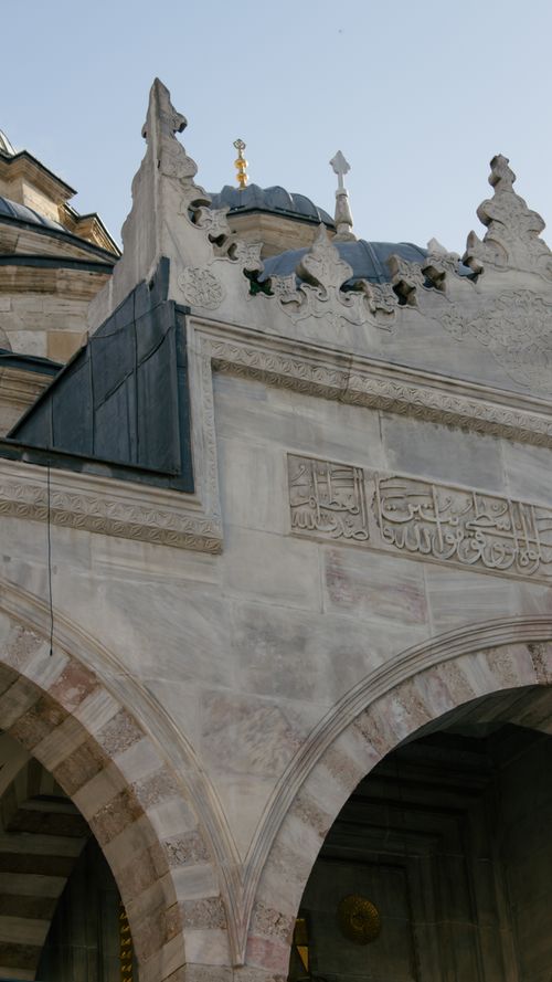 Free Detailed view of Ottoman mosque facade with intricate stone carvings in Istanbul, Turkey. Stock Photo