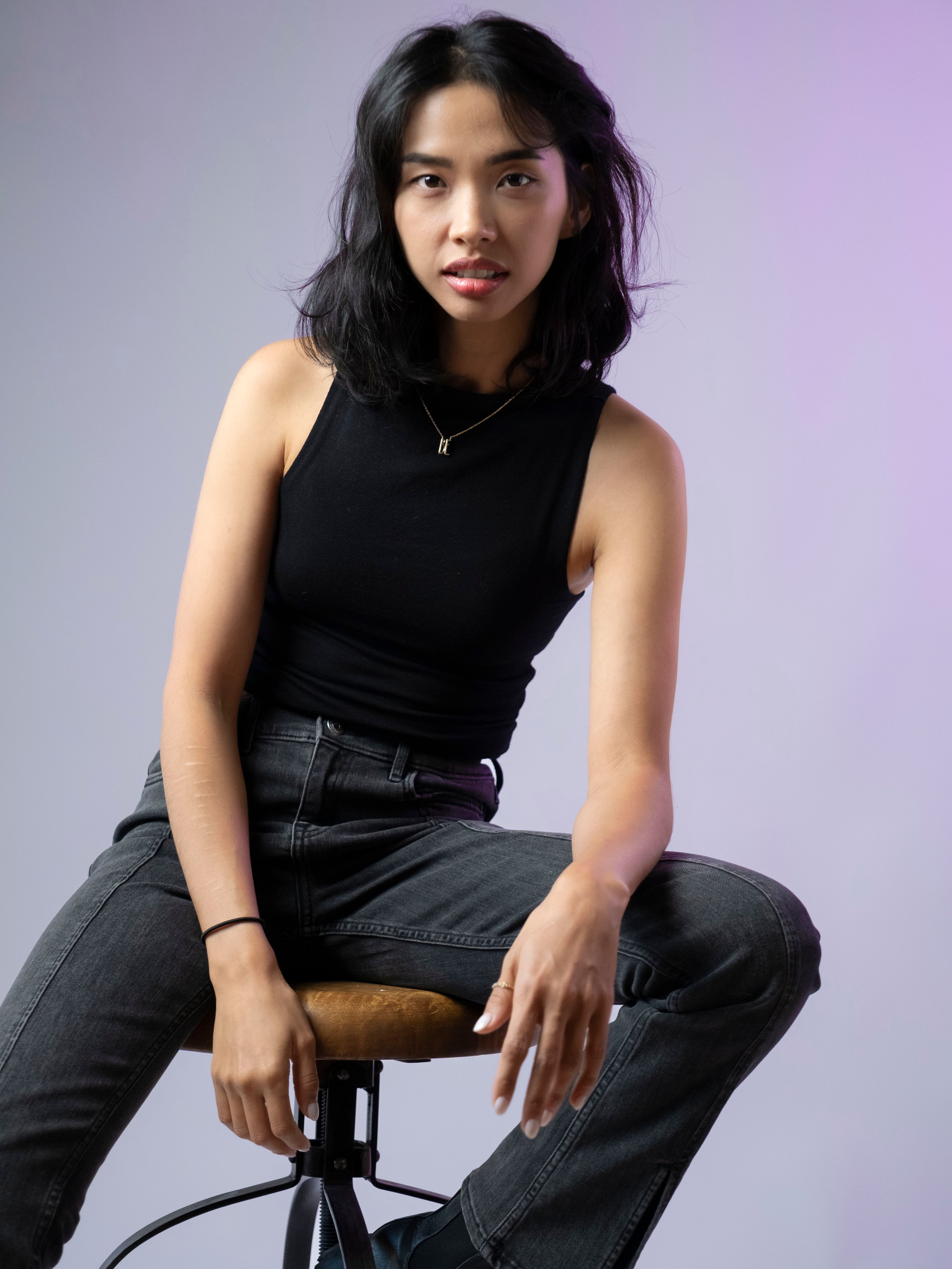 Fashion-forward portrait of a woman in a studio setting, showcasing modern style.