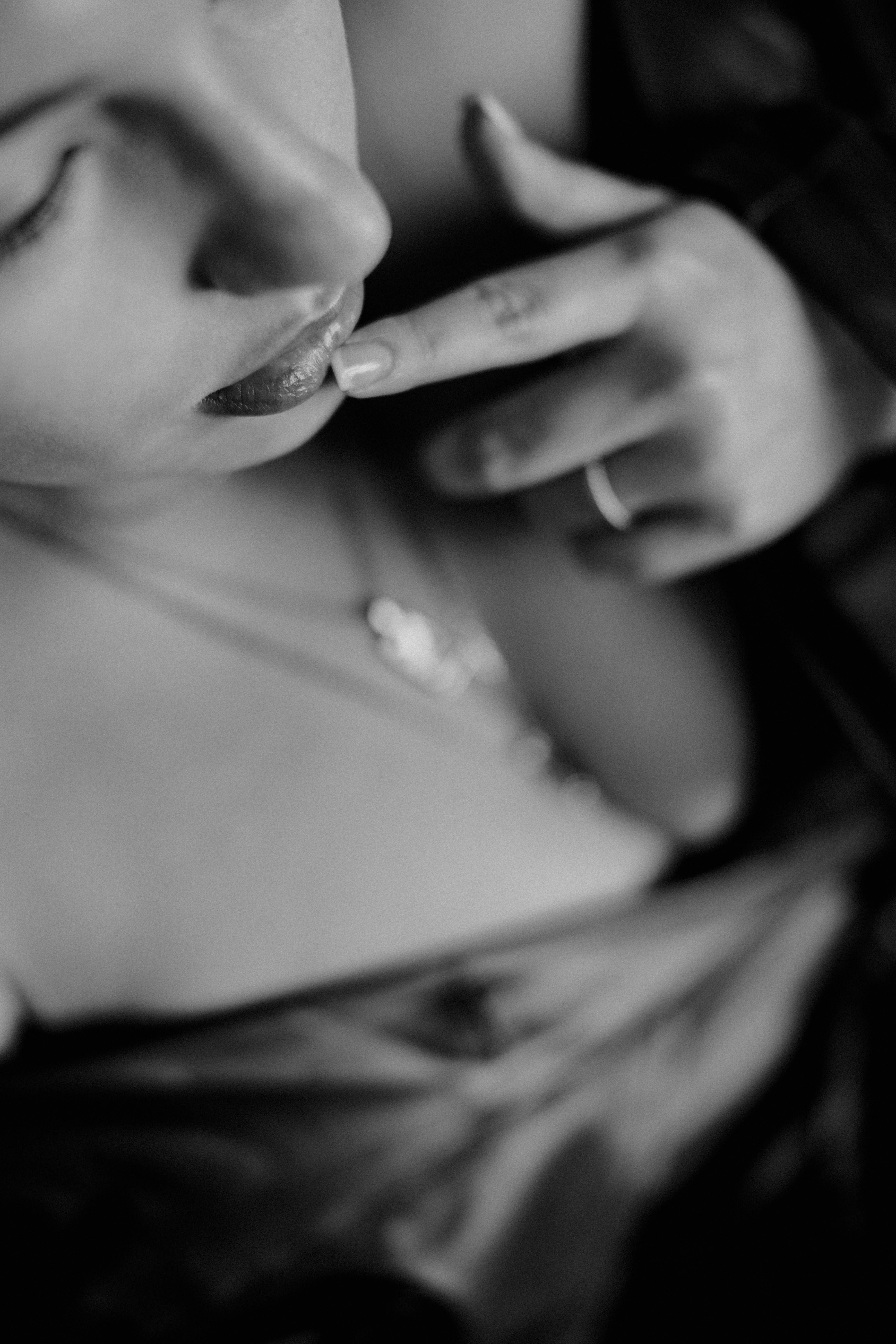 Close-up black and white portrait of a woman with soft, sensual expression.