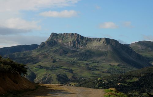 Free Breathtaking view of lush green mountains in Algeria under a clear blue sky. Stock Photo