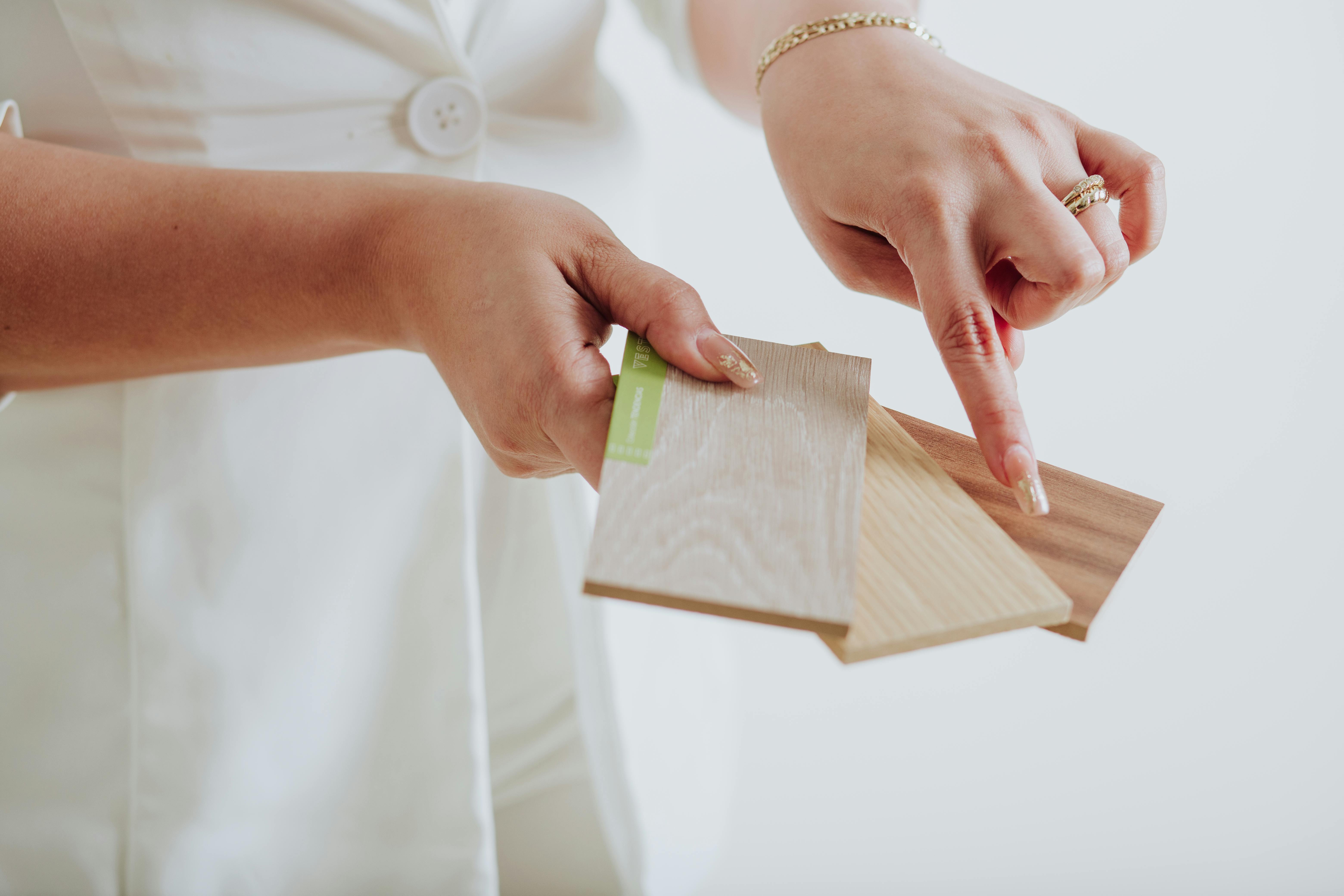 close up of a woman holding wood samples