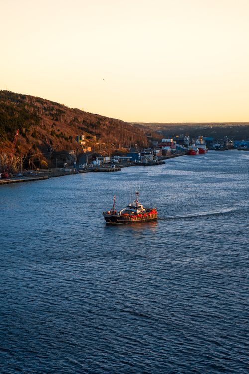 Aerial View of a Vessel on a Body of Water at Sunset · Free Stock Photo
