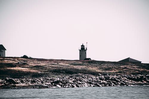 Landscape Photo of a White and Black Lighthouse