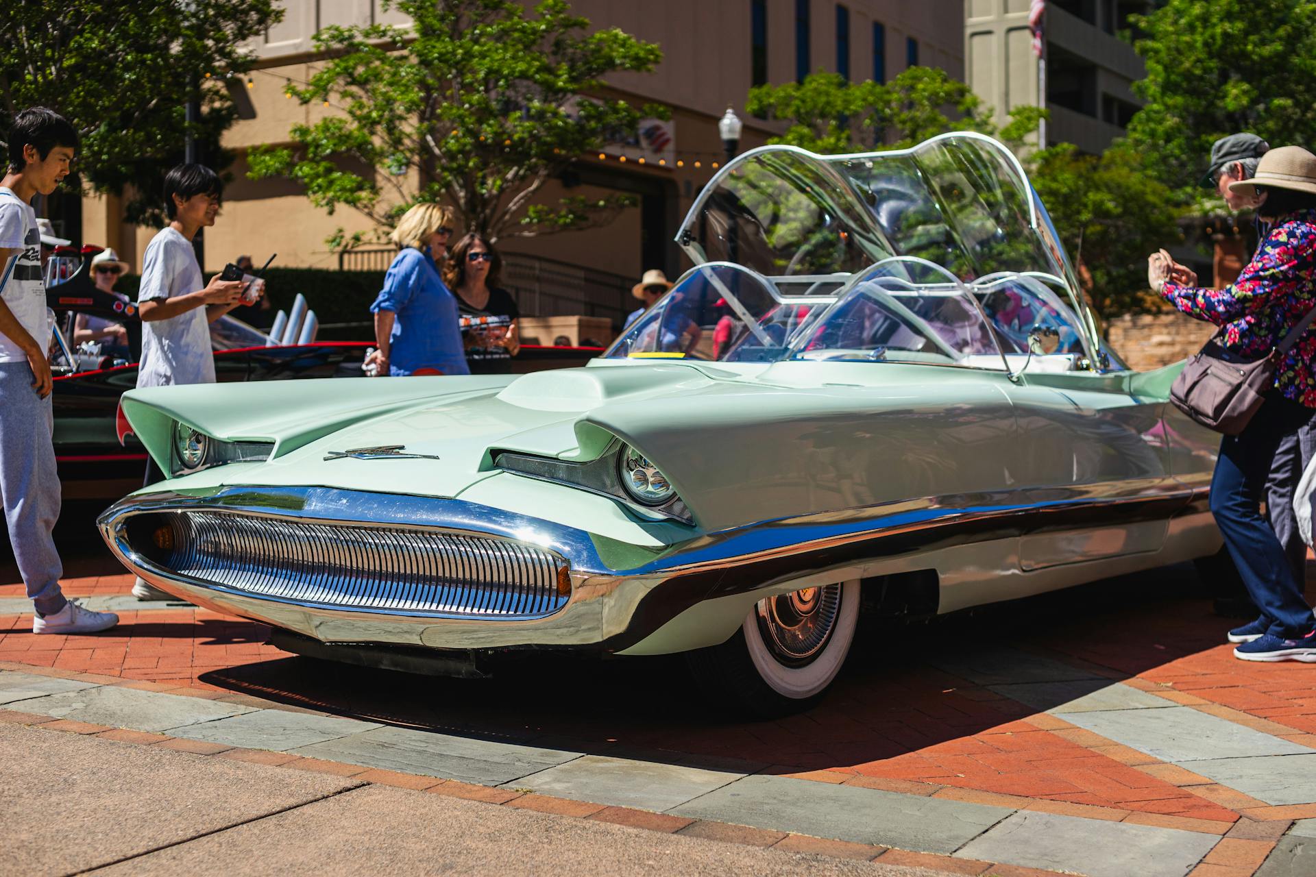 A classic Lincoln concept convertible on display outdoors, surrounded by interested onlookers.