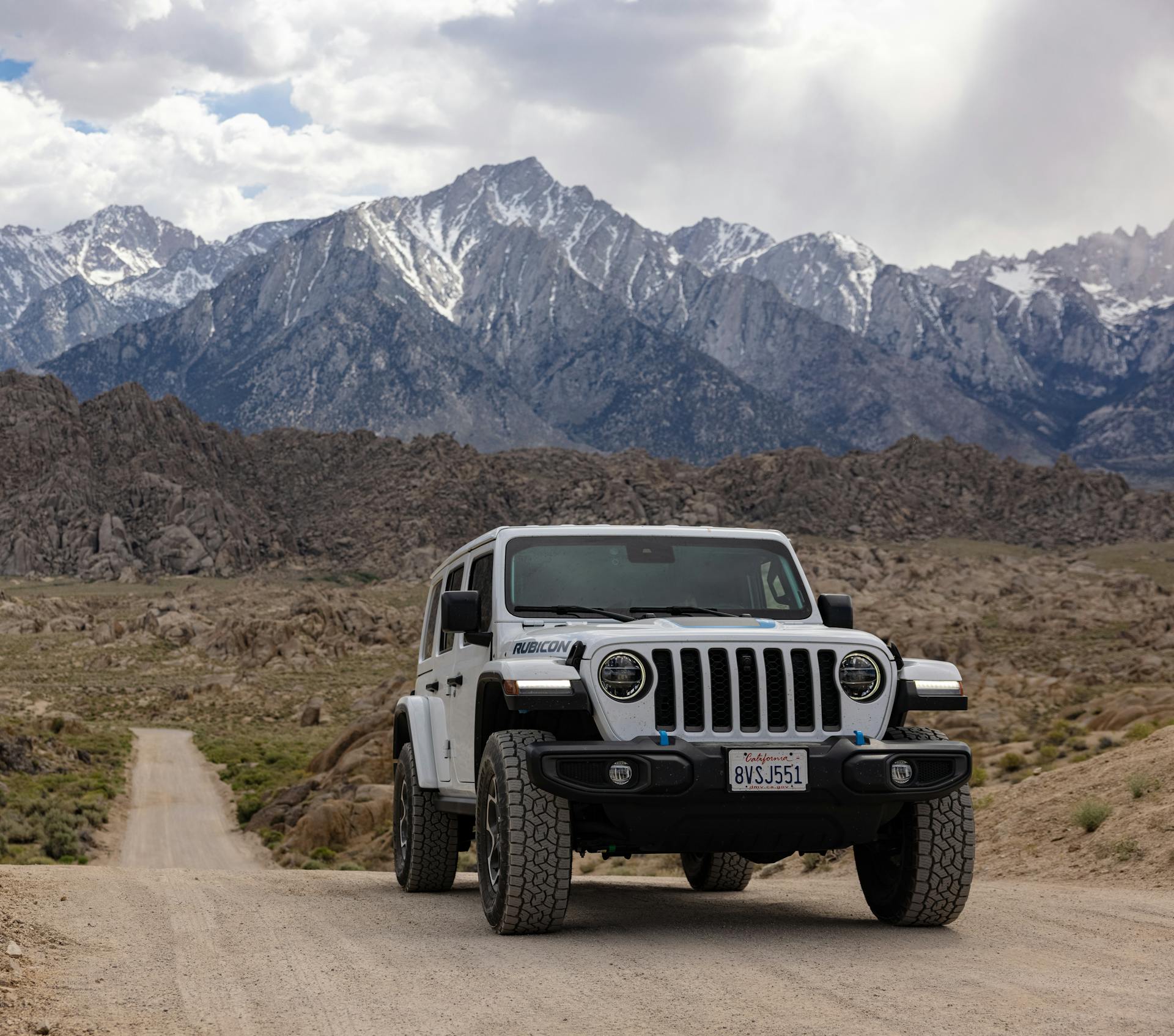 White Jeep Wrangler on Dirt Road in Mountains