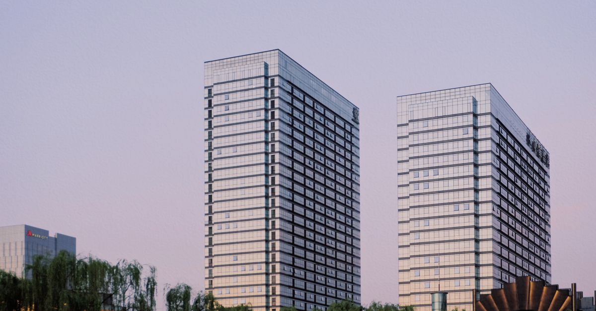 Elegant glass skyscrapers reflecting the evening sky in a modern cityscape.