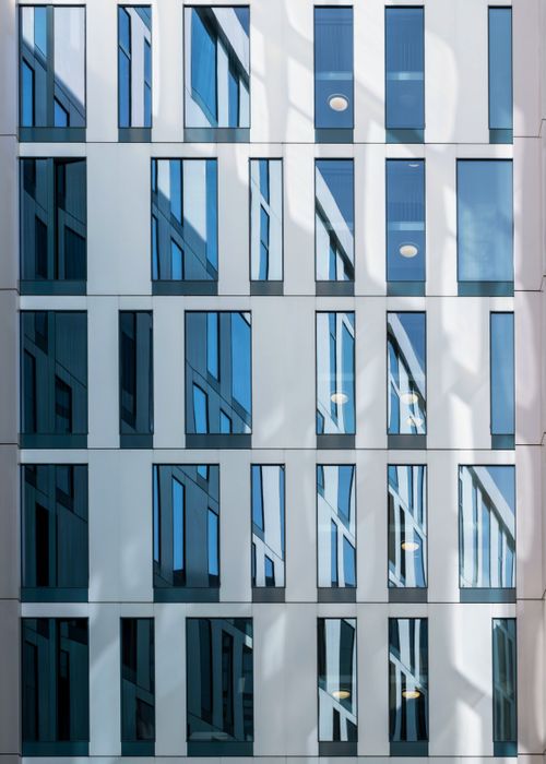Free Abstract view of a glass facade reflecting the urban architecture of Hamburg. Stock Photo