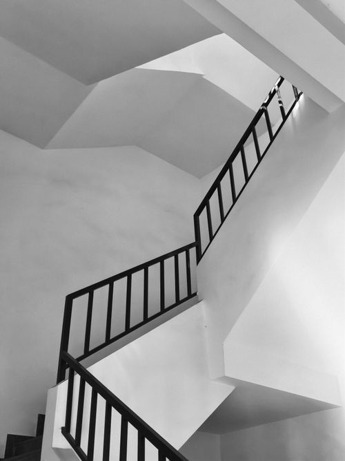 Free Black and white photo of a modern staircase with geometric lines, showcasing contemporary architectural design. Stock Photo
