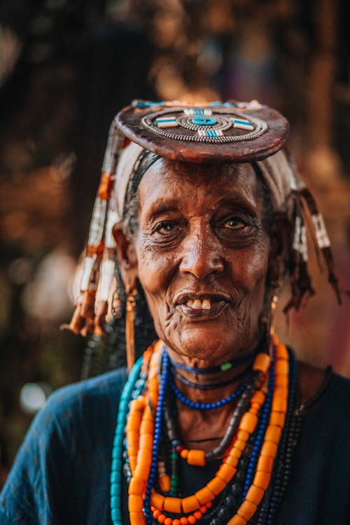 An old woman with a headdress and beads