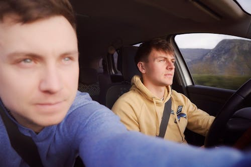 Two men are driving in a car together