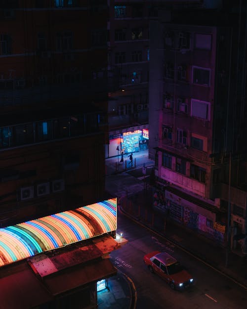 Red Car Traveling on Road At Nighttime