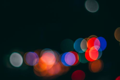 Free Colorful and defocused city lights create a vibrant bokeh effect at night. Stock Photo
