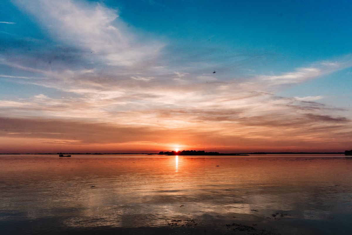 Silhouette of a Boat on the Sea during Sunset · Free Stock Photo