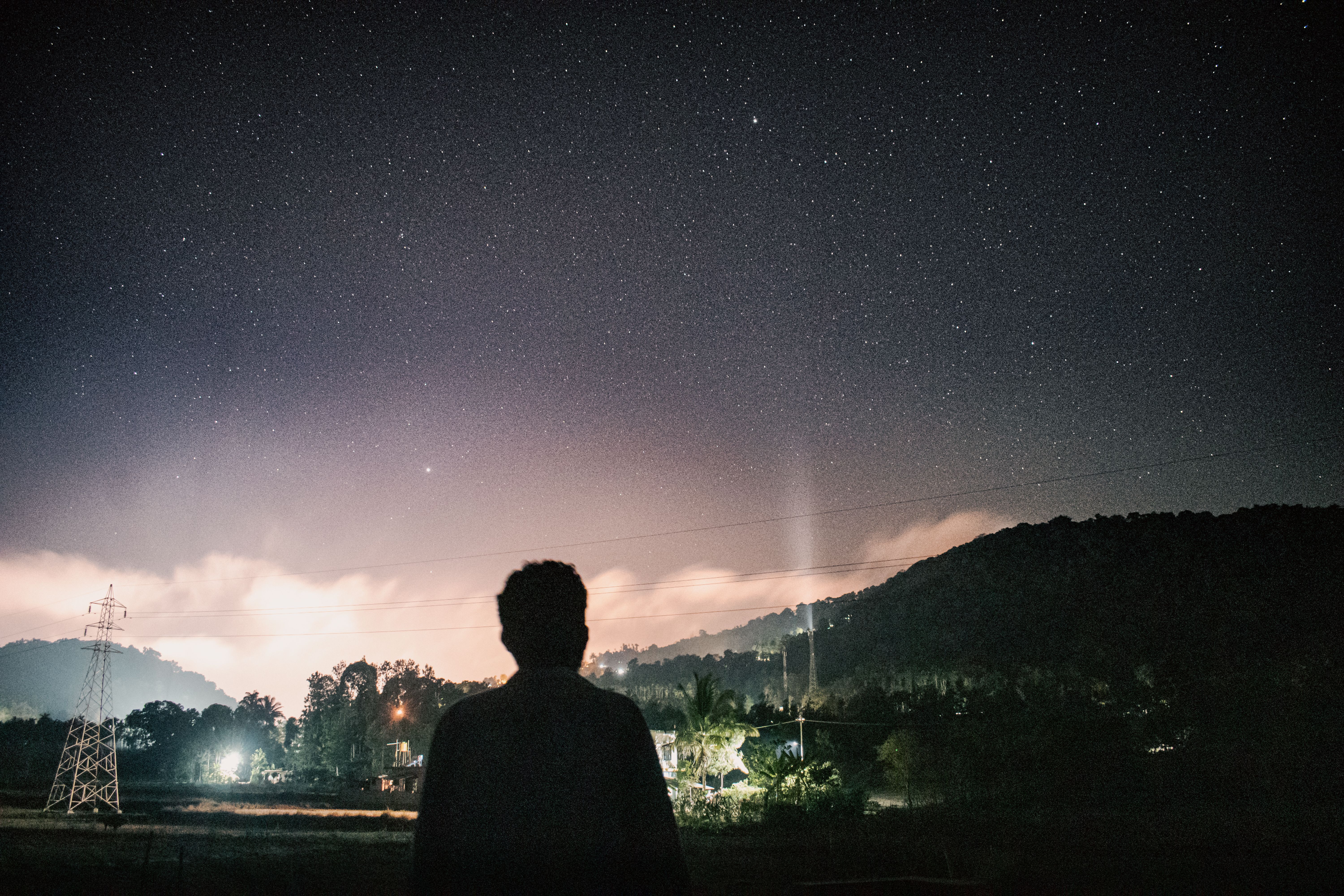Person stargazing under beautiful night sky