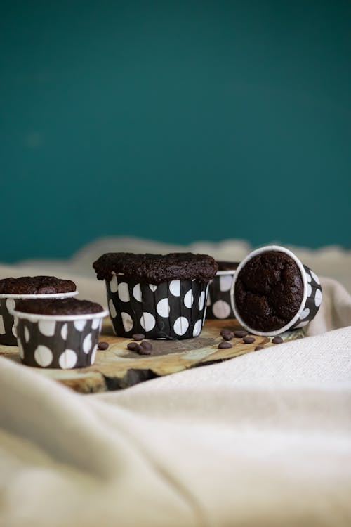 Chocolate cupcakes in cups with polka dots on top