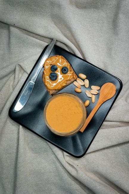 Top view of a stylish breakfast spread with peanut butter and blueberries, enhancing home dining.