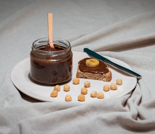 A plate with peanut butter and chocolate spread