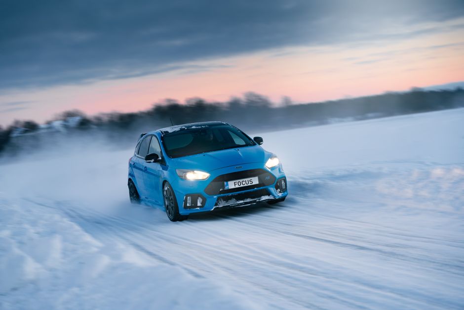 Close-up of a car's winter tire on a snowy road in Sweden