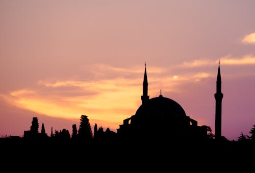 The silhouette of a mosque at sunset