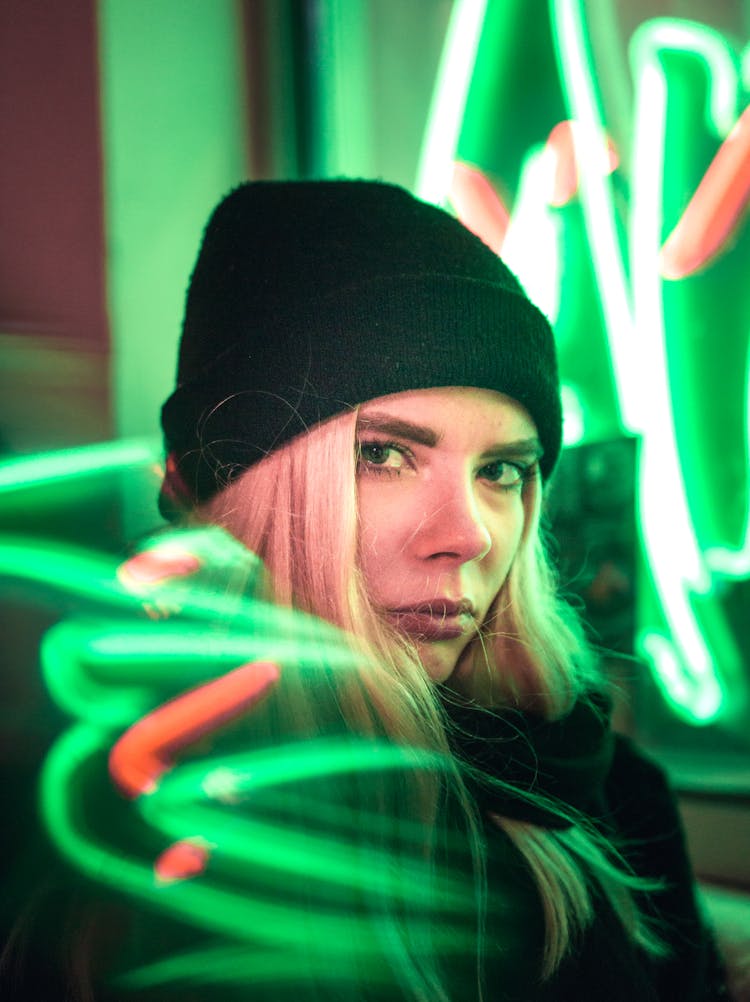 Woman Frowning Near Green Led Light