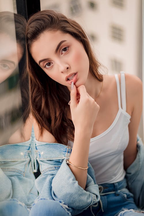 Free Woman Leaning on Glass Window Stock Photo