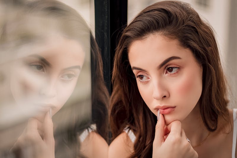 Woman contemplating by window