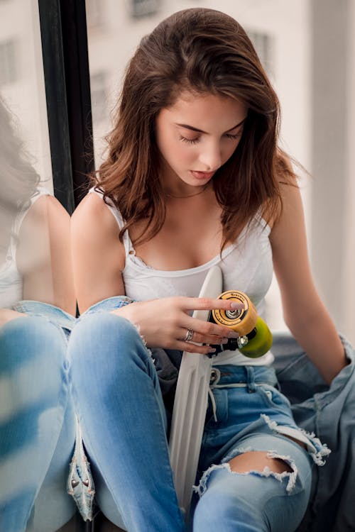 Woman Holding White Skateboard