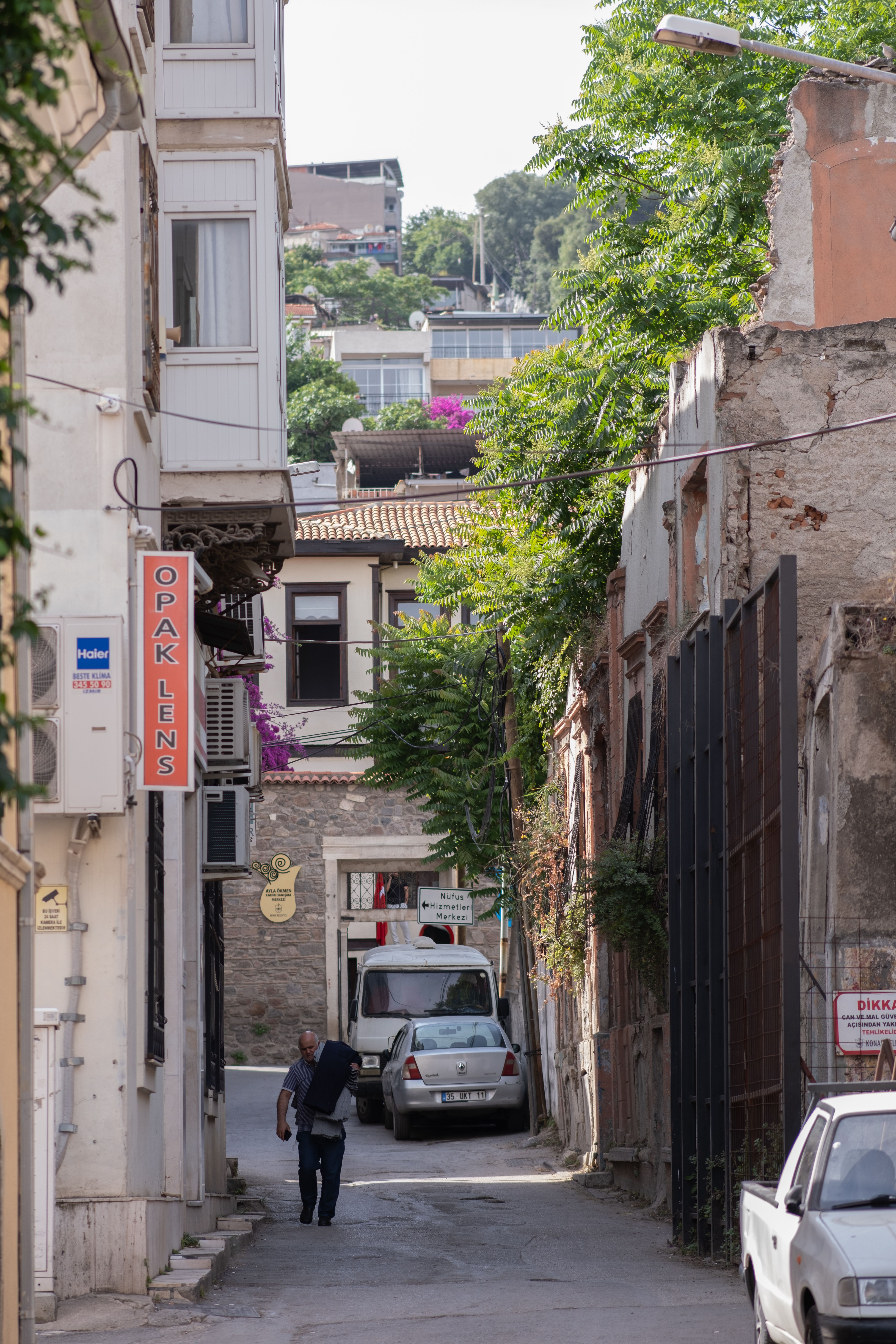 A Man Walking in a Narrow Alley between Buildings in a Town · Free ...