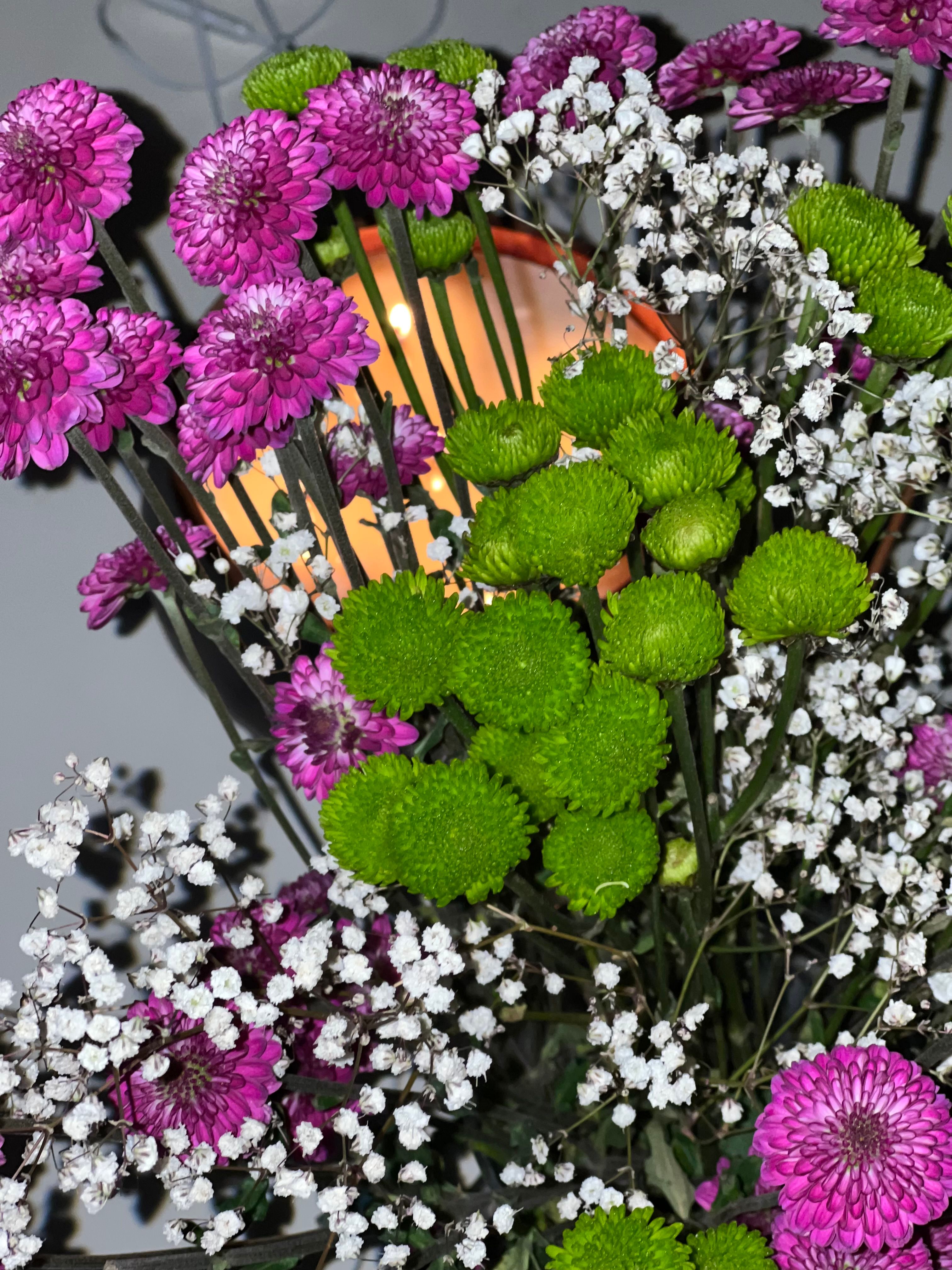 [ColoSach]-close-up-of-a-colorful-floral-arrangement-featuring-pink-chrysanthemums,-green-button-flowers,-and-white-baby's-breath.