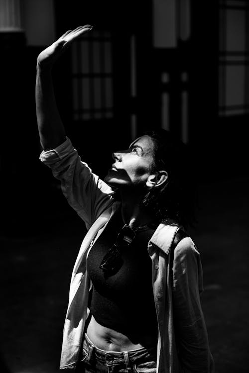 A woman is holding up her arms in the air