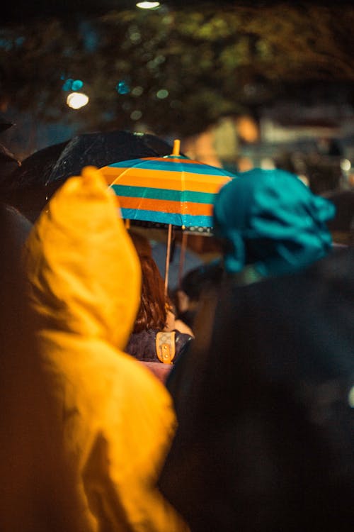 Free Woman Holding Orange And Teal Umbrella Stock Photo
