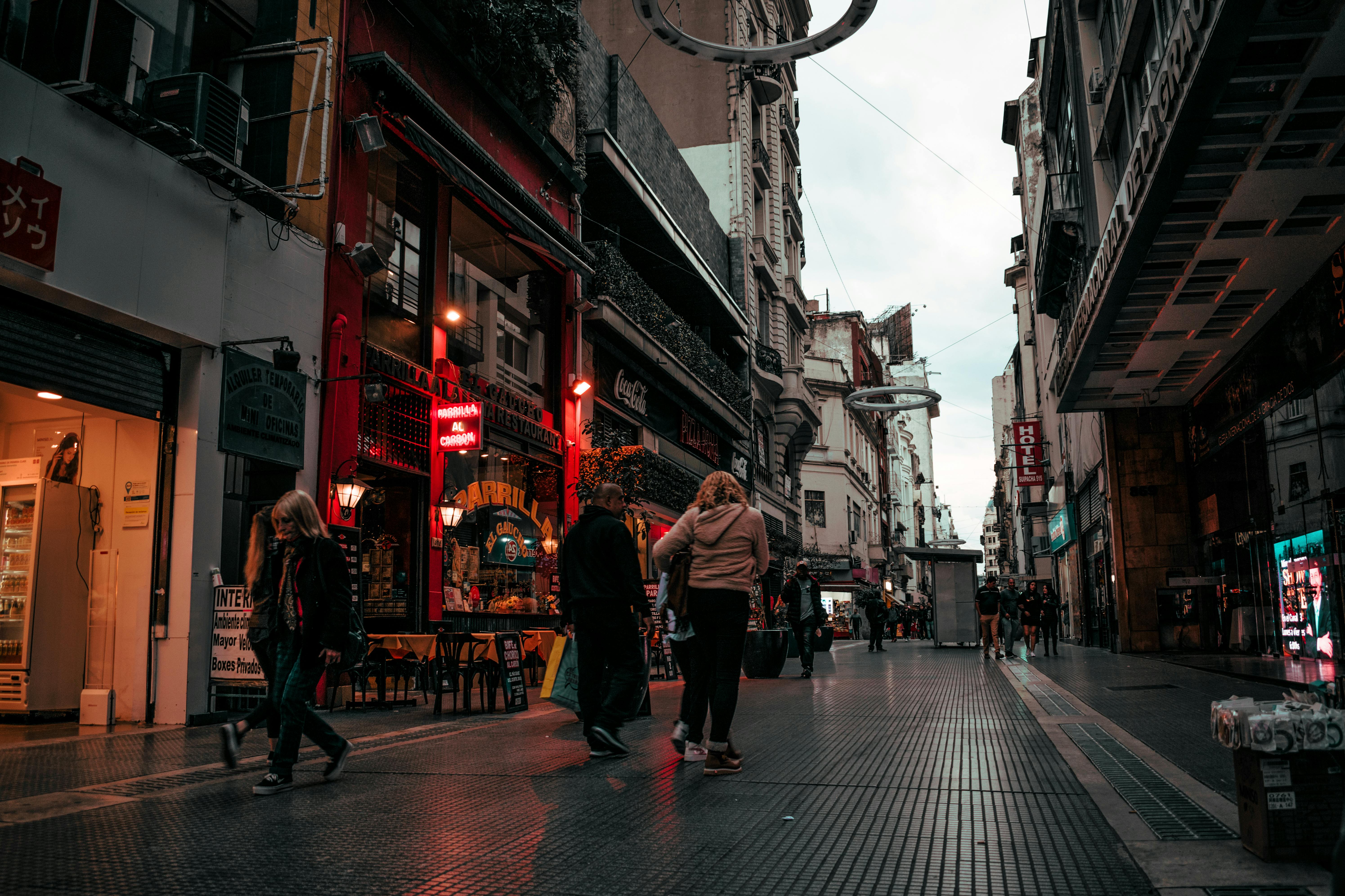 people walking on alley near buildings