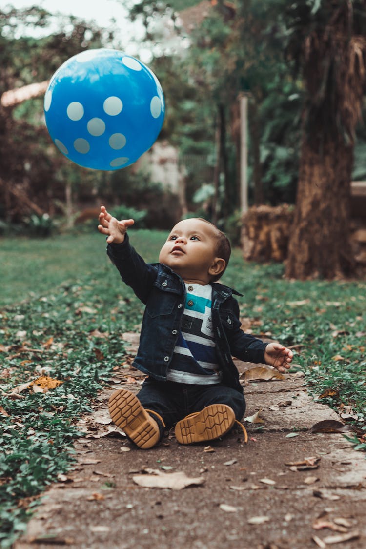 Toddler Playing With A Balloon