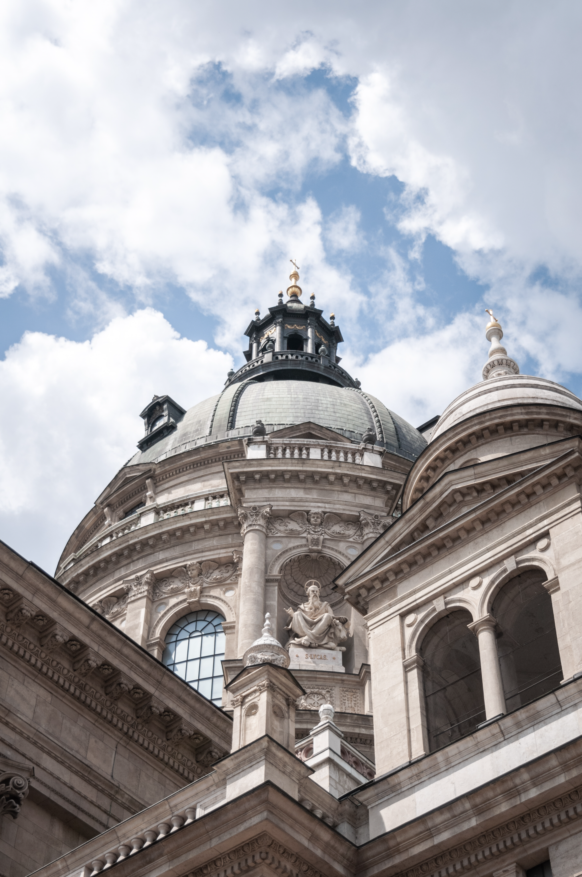 Low-angle shot of St. Stephen's Basilica against a cloudy sky in Budapest, Hungary.