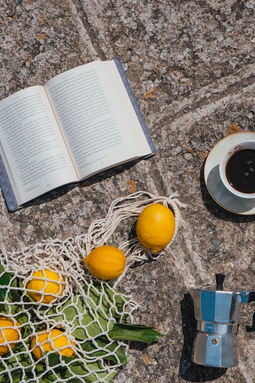 Free Book, Coffee Pot and Torn Bag of Lemons Stock Photo