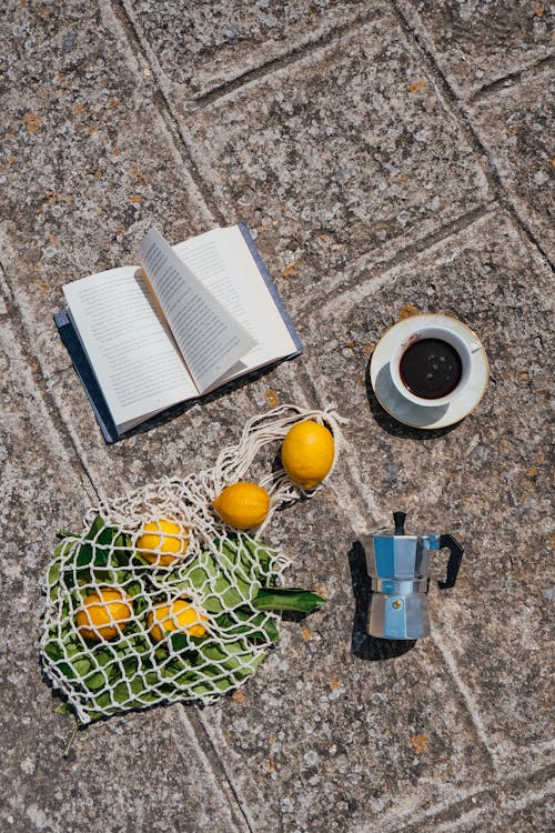 Free Book, Coffee, Coffee Pot and Torn Bag of Lemons Stock Photo