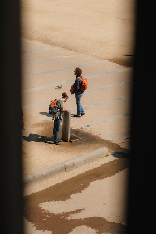 A man and a woman are standing in front of a building